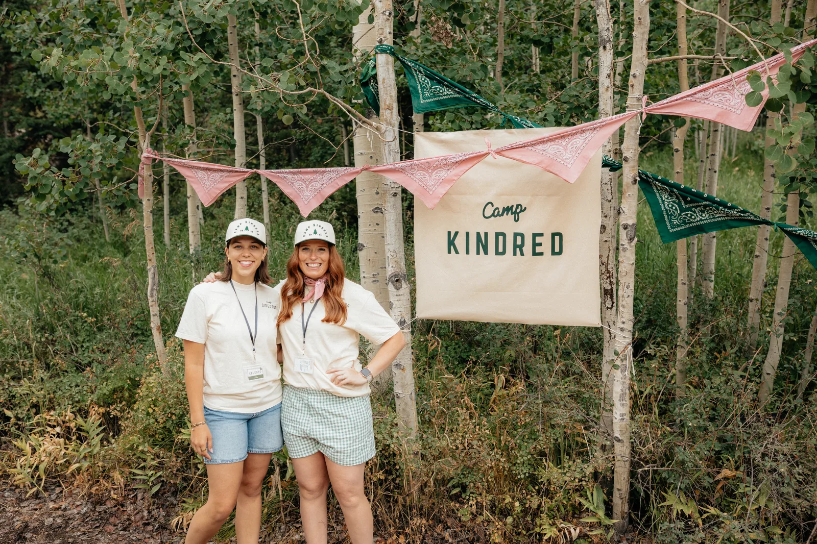 Celeste and Kiah, the Camp Kindred directors, standing together in an aspen grove